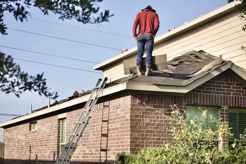 Professional roofer working on a residential roof in Pleasant Garden